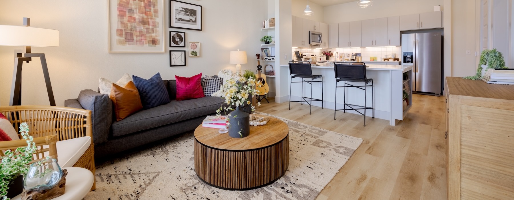 living area with a large window, coffee table and chair